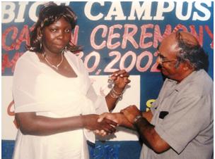 Receiving a prize in 2002 from then Region 6 Chairman, Rohit Persaud, for graduating with a distinction at the University of Guyana Berbice Campus