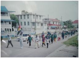 Hazel (in front bearing flag) leading the first Fitness Walk from Canje to New Amsterdam in 2003